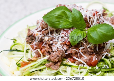meat sauce with fresh garter cheese and green zucchini cut like spaghetti for a pasta substitute