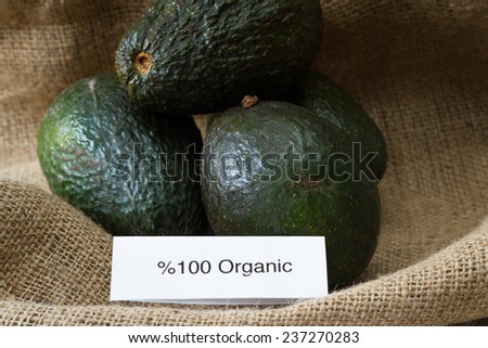 food labeling concept with local organic avocados and an organic label