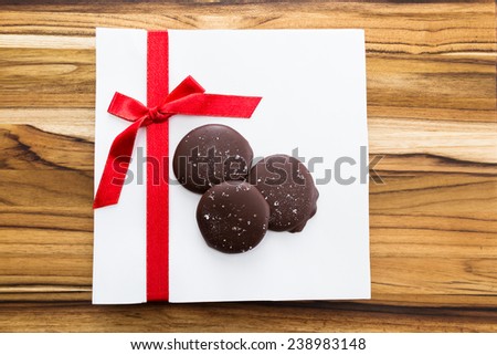home made sea salted caramels on a white background with a red ribbon