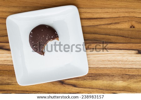 home made sea salted caramel on a white plate with a bite mark