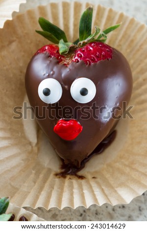 chocolate covered strawberry hand dipped and decorated with eyes and red lips