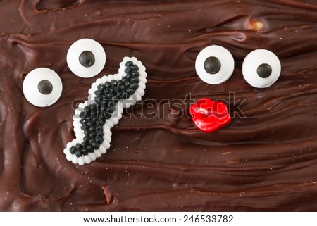 funny faces representing of a man with a mustache and a female with red lips in home made chocolate fudge