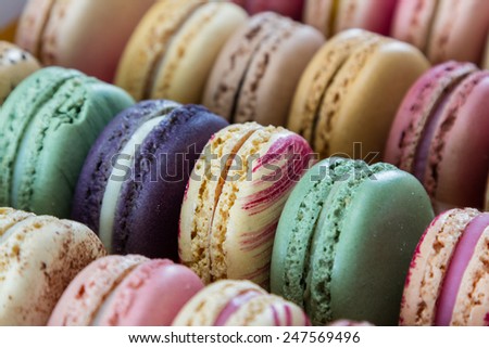close up of a box with a variety of home made french macaroons with pastel colors