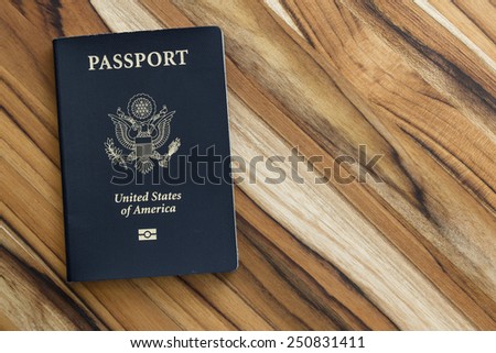 close up of an american passport on a wooden table for a travel concept