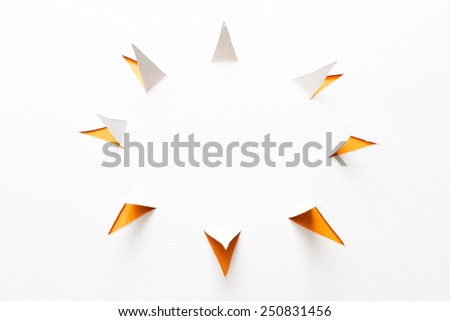 abstract paper cut with triangles around a main circle to form the sun shape on white