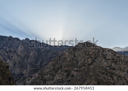 Afternoon view of the San Jacinto Mountains in California with the sun rays glowing thru the smog layer