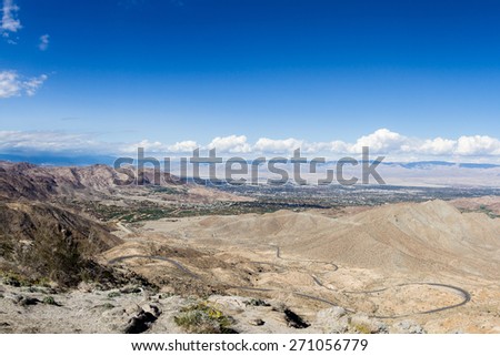 view of the desert valley from the top of a mountain in southern California, and to road to get to the top.