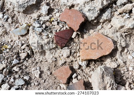 close up of small pieces of pottery left behind on the desert ground for hundreds of years in Arizona