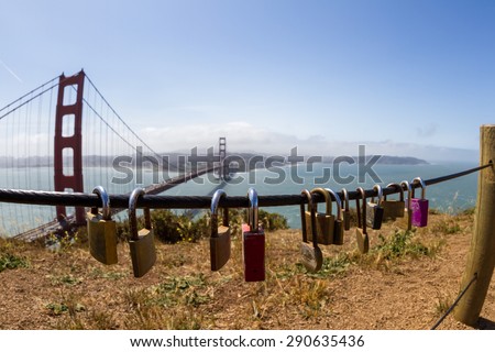 San Francisco, California - May 11 : Padlocks on a safety line overlooking  he Golden Gate Bridge, May 11 2015 San Francisco, California.