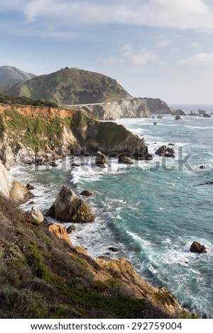 dramatic landscape of the California coast with waves splashing on the cliffs and rocks