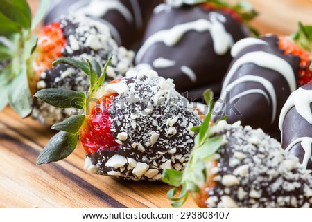 Hand dipped strawberries in chocolates with some rolled in roasted cashews and some with a white chocolate drizzle
