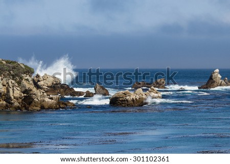 dramatic powerful waves crashing on rocks of the California Coast