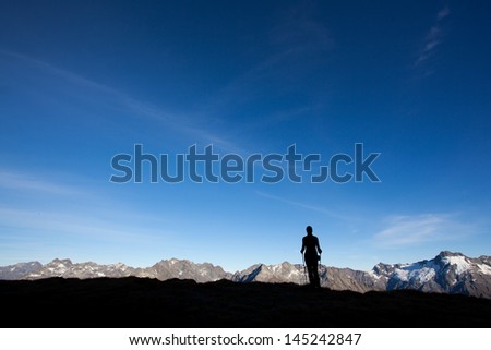 Silhoutte of a mountain hiker, big copy space