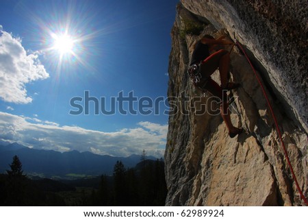 Rock climbing. Young woman climbing a limestone rock