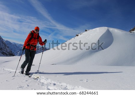 Young woman doing ski touring. Outdoor winter activity
