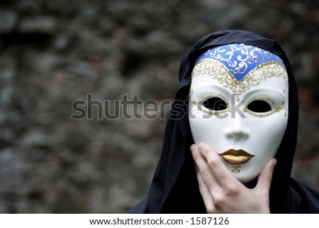 Man behind clay Venetian style mask