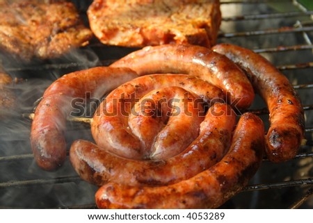 Rolled sausage and pork chops in the grill