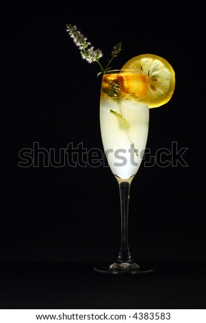 Layered rum cocktail with lemon slice and mint blossom decoration