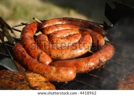 Rolled sausage and pork chops in the grill