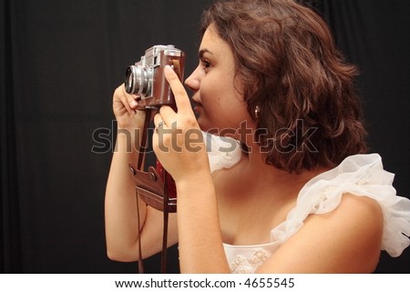 Beautiful bride with old analog camera