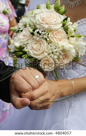 Just Married. Hands and bridal bouquet