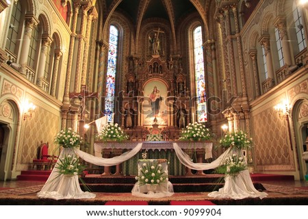  of a catholic church beautifully decorated for a wedding ceremony