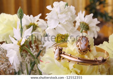 Cameo jewelry set with ring, bracelet and pendant on flowers