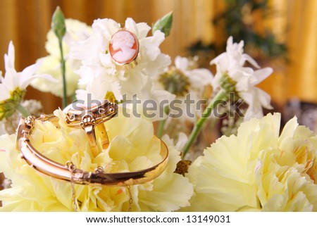 Cameo jewelry set with ring, bracelet and pendant on flowers