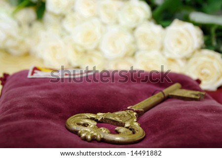 Symbols of graduation from university: bronze key and roses