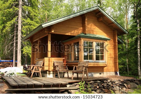 Wooden cabin with table and chairs on the terrace