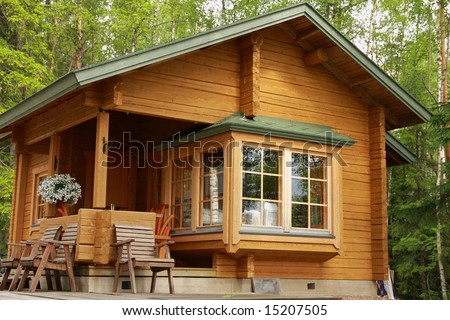 Wooden cabin with table and chairs on the terrace
