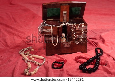 Beautiful antique wooden box filled with jewels
