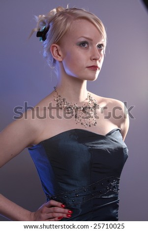 Beautiful young woman wearing a blue prom dress