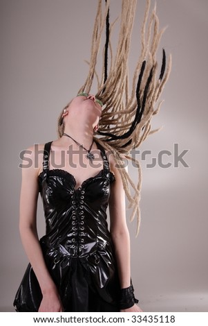 Young woman with dread locks and punk clothing, moving hair