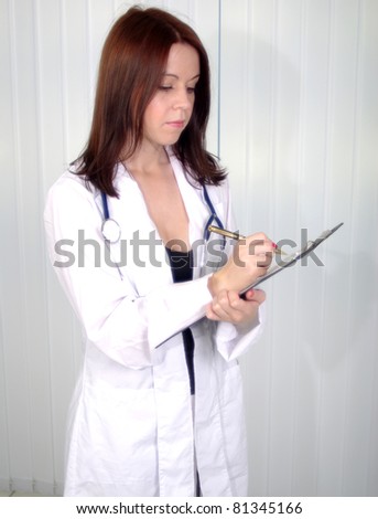 Attractive young doctor on working in cabinet with tablet