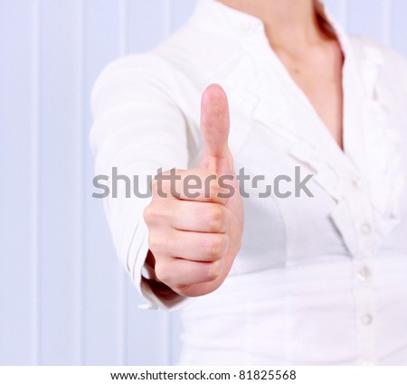 portrait of beautiful young success woman giving thumbs