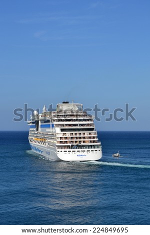 Cruise liner Aida leaving port of Valetta, Malta. At Valetta port, Malta - May 1st, 2011, cruise liner Aida with passengers onboard leaving port of Valetta, accompanied by pilot boat.
