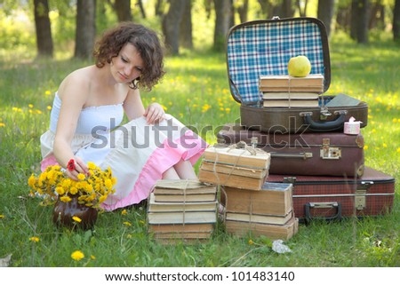 Romantic girl dreaming of books around in the park