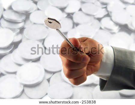 businessman hand offering a key, shiny coins in the background