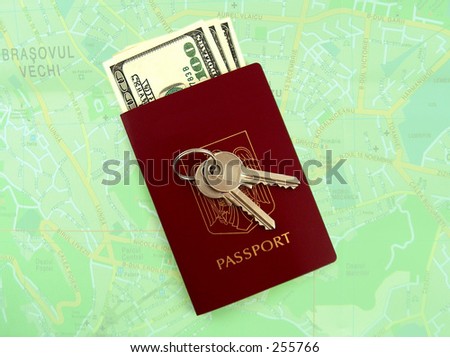 keys, passport and dollars, green map in the background