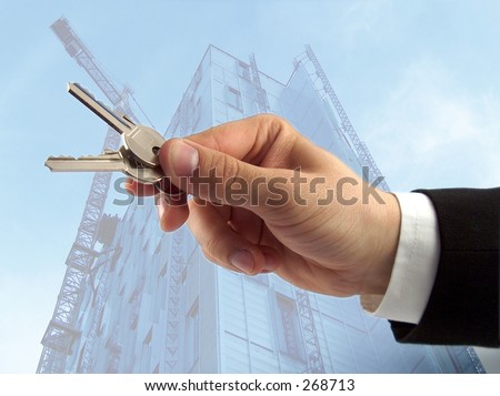 businessman hand offering keys, sky-scraper in the background