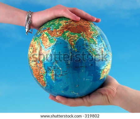 hands holding the earth, clear sky background