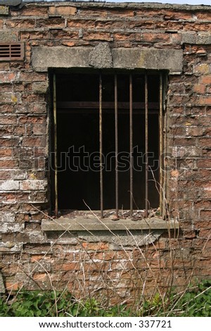 Window with rusty bars in old building
