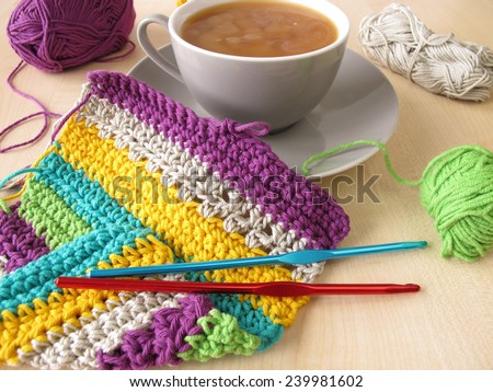 Crochet work and a cup of coffee with milk