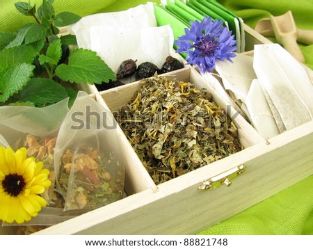 Tea variety with loose tea, tea bags and fresh tea herbs