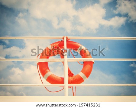 life belt (6), life buoy, red rescue ring on a ship against blue sky with clouds