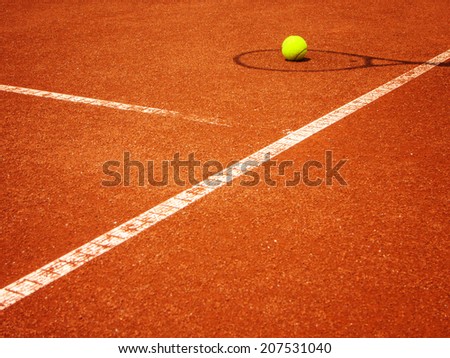 tennis court t-line with racket shadow and ball