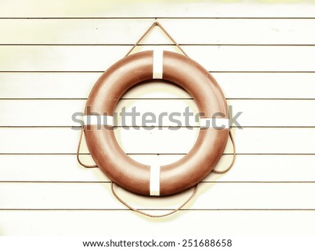 life belt, rescue ring on wooden wall