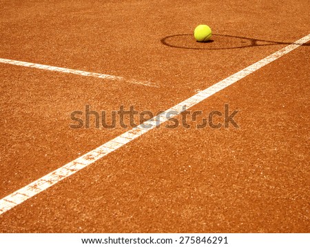 tennis court t-line with racket shadow and ball
