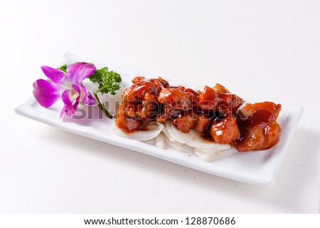 Chinese sweet and sour pork on a white plate